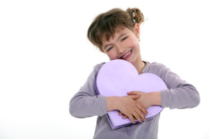 Girl holding a heart-shaped box